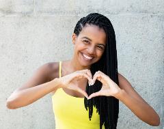 Woman forming heart with hands